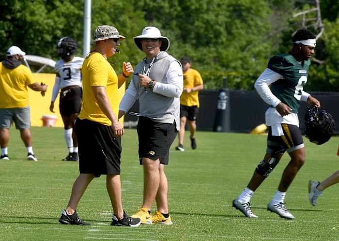 Missouri head football coach Eli Drinkwitz, center, smiles with Ryan Russell, executive director of athletic performance, on the first day of fall practice Monday at the Kadlec Practice Fields. The Tigers are scheduled to open the season Thursday, Sept. 1 against Louisiana Tech